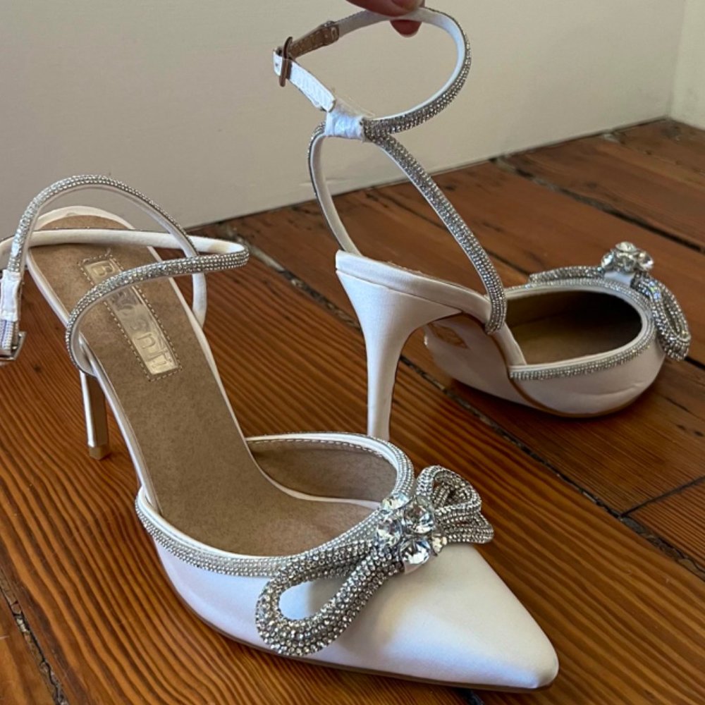 White pointed toe crystal bow embellished pumps